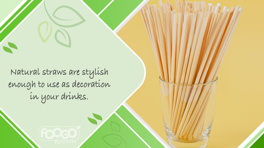 A reusable glass containing a clutch of natural wheat drinking straws