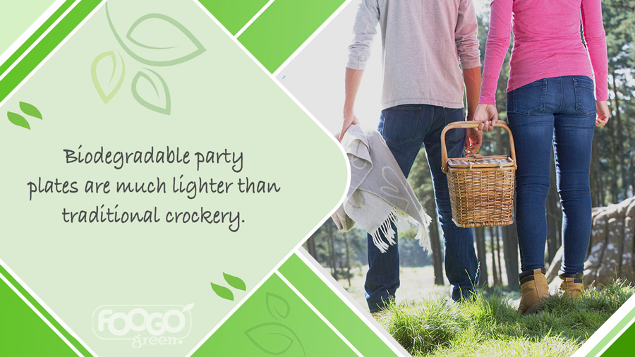 Couple carrying compostable plates in picnic basket