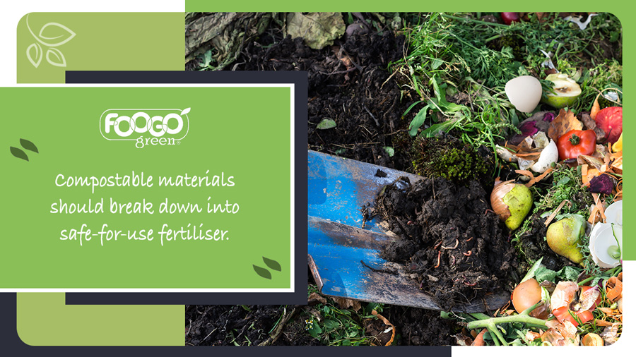 Gardener applying biodegradable material to soil as compost