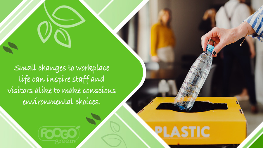 Office worker placing plastic drinks bottle into a recycling bin for collection