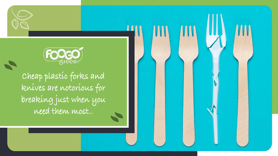 A broken plastic fork situated amid strong wooden eco-friendly cutlery